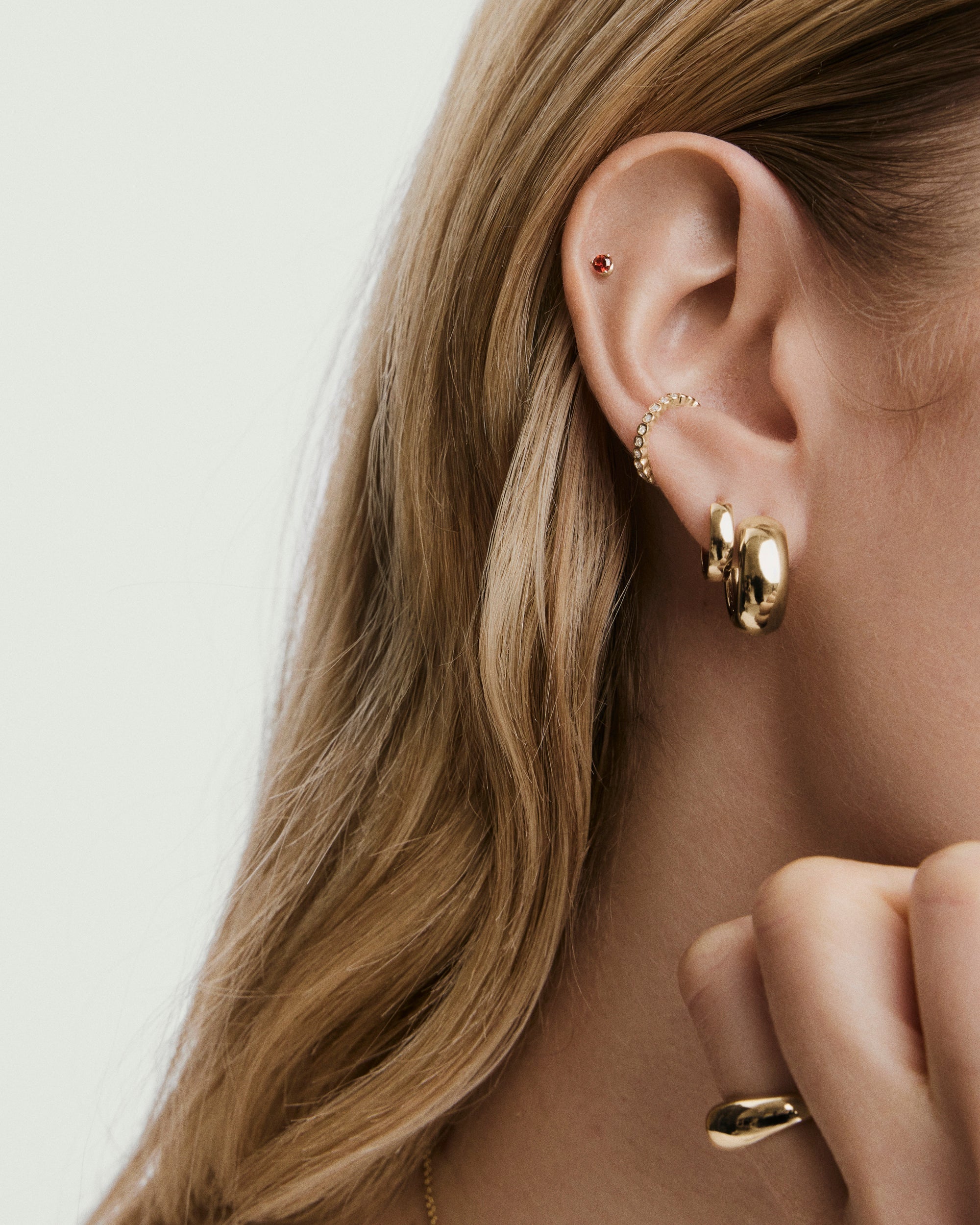 1-BirthstonePiercingStuds_BirthstonePiercingStudJanuaryGarnet_YG_Stack_031_ecd47d90-d7f3-476a-8637-2d0e1d0f8f01